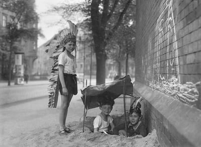 Kinder spielen auf der Straße mit einer Zeltgrube